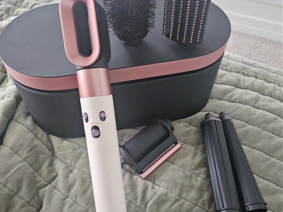 A pink Dyson Airwrap and accessories.