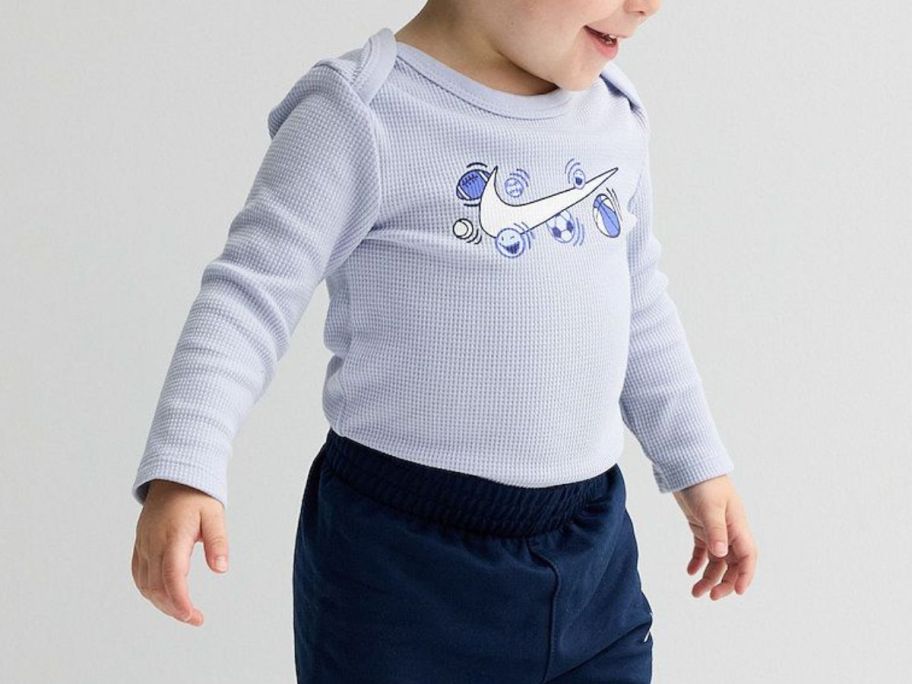 kid wearing Baby Boys Nike Sports Balls Long Sleeve Bodysuit & Pants 2-Piece Set