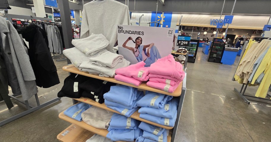 gray, black, pink and blue sweats folded on display 
