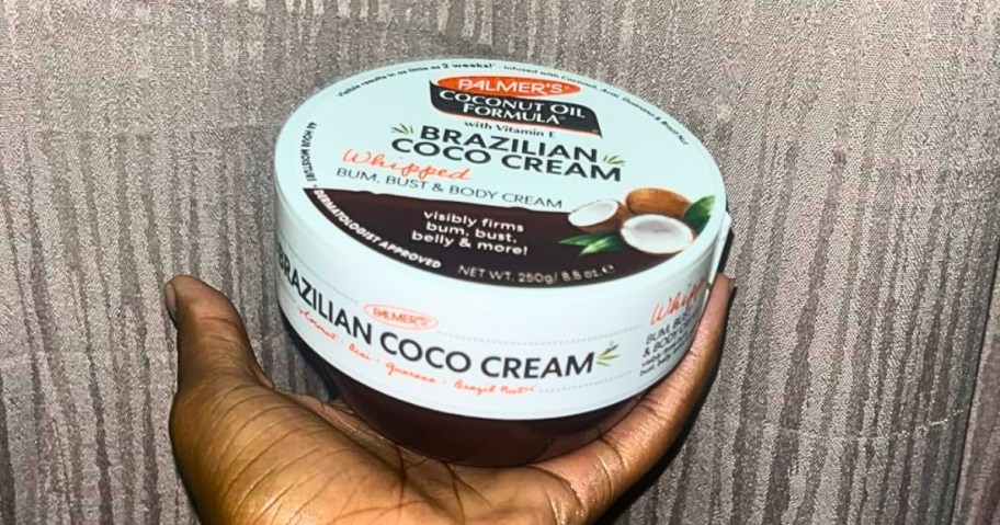 hand holding a container of Palmer's Brazilian Coco Cream 