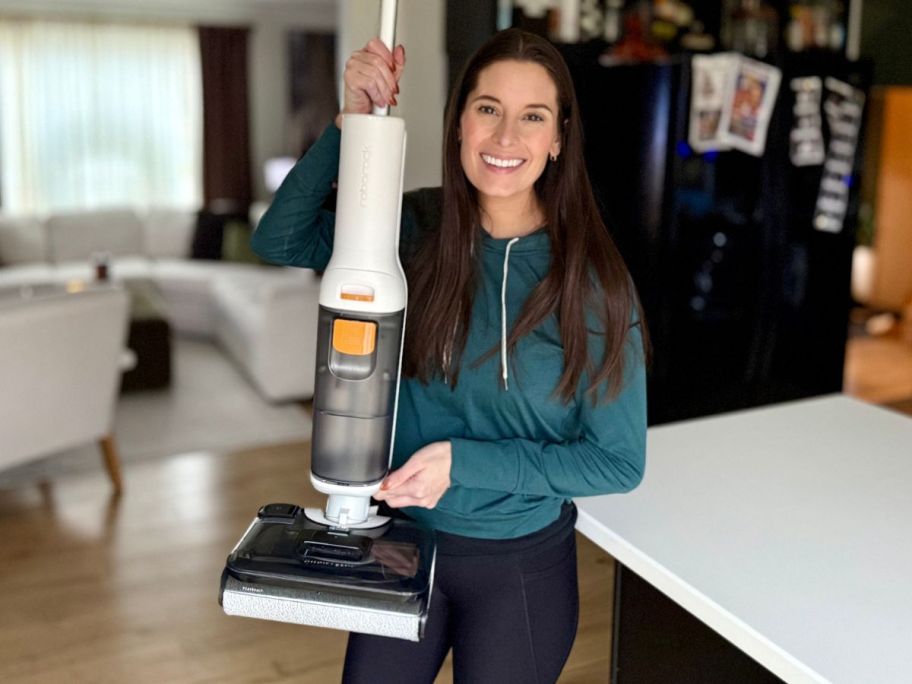 emily holding Roborock All-in-1 Vacuum