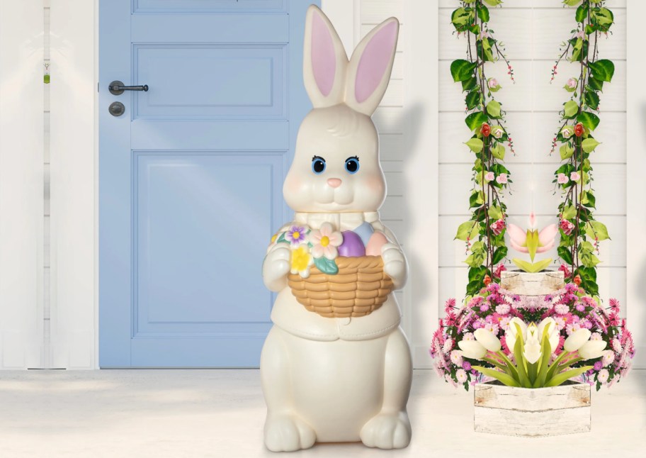 blow mold white bunny in front of blue door