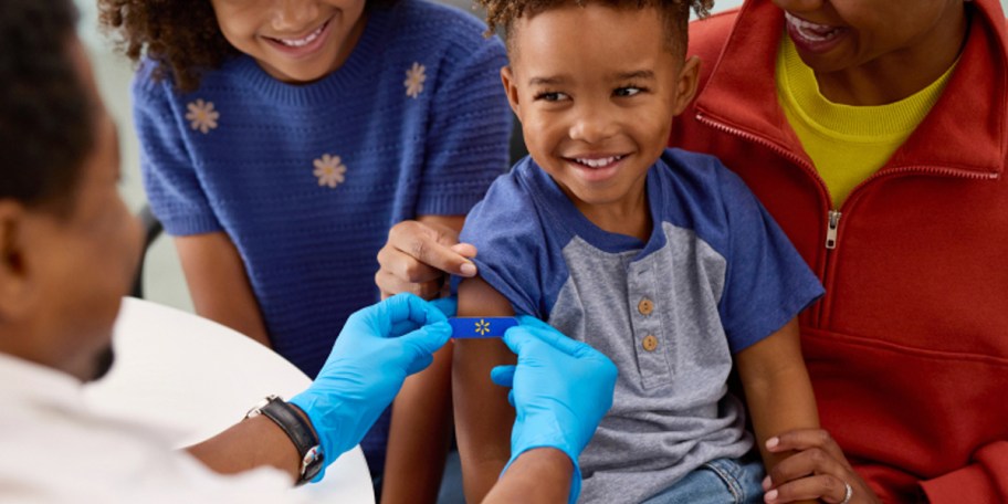 doctor putting bandaid on child 