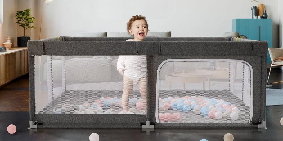 baby in gray playpen
