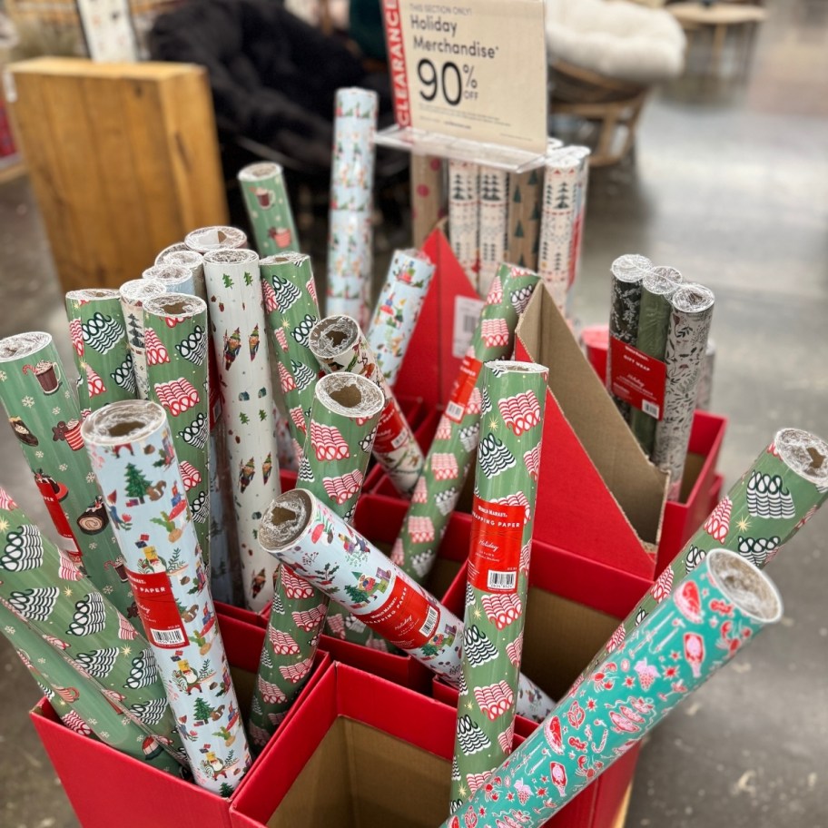 various rolls of gift wrap in a store display