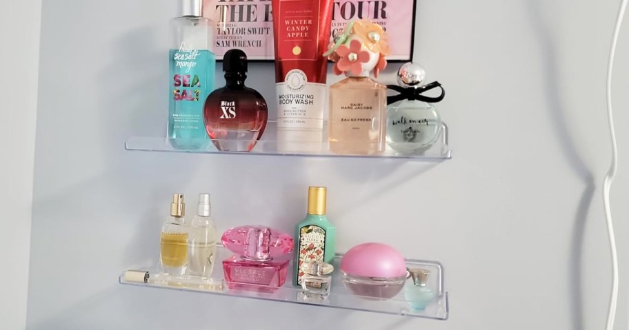 perfume bottles on clear floating shelves