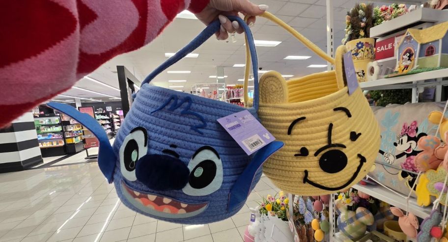 hand holding lil & stitch baskets plus pooh 