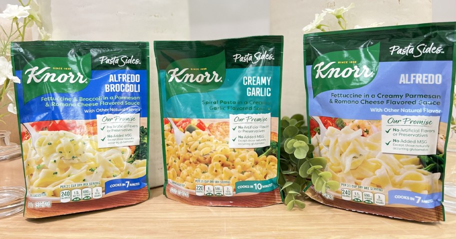 three bags of Knorr Pasta Sides on a wood table
