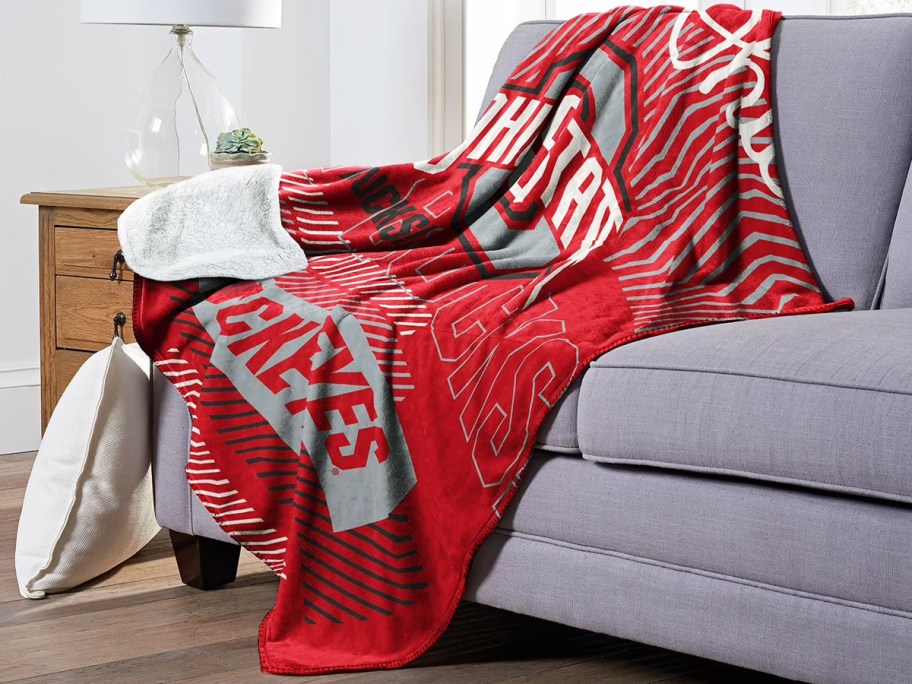 ohio state themed throw blanket draped over a couch