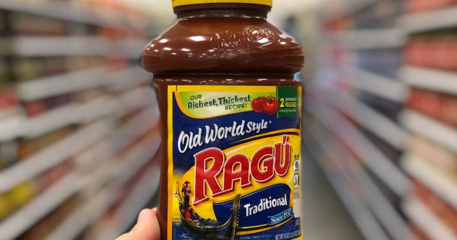 Hand holding a large jar of Ragu Old World Style pasta Sauce