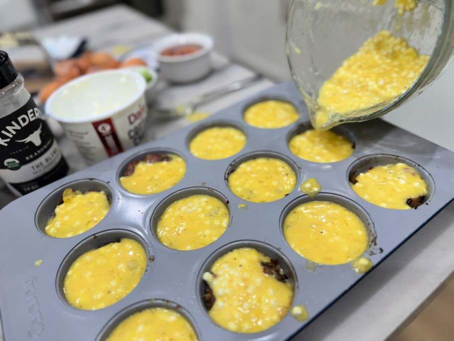 adding egg mixture fillingto muffin pan 