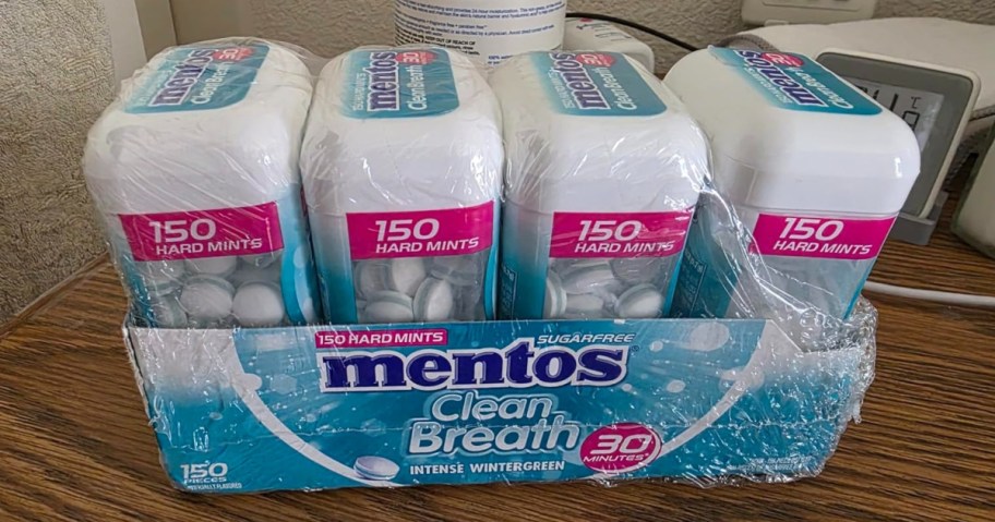 A package of Mentos Clean Breath sugar-free mints, featuring four containers, each with 150 hard mints, wrapped together.