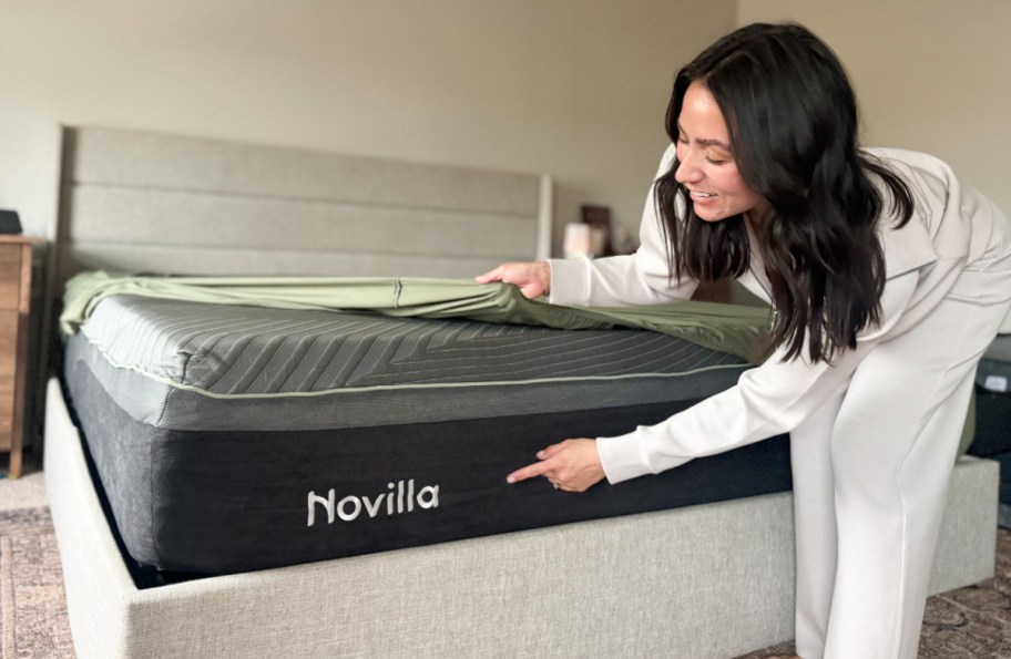 woman pointing to the Novilla label on a mattress
