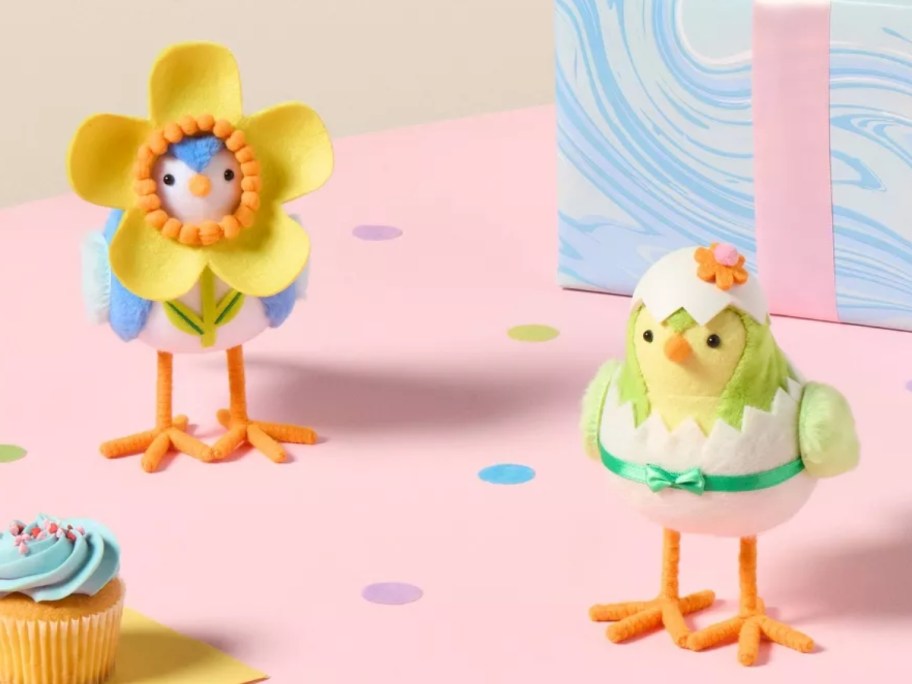 decorative Easter birds, one has a flower around it's head and one is cracking out of an egg