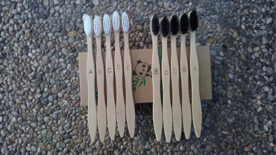 black and white bamboo toothbrushes displayed with boxes 