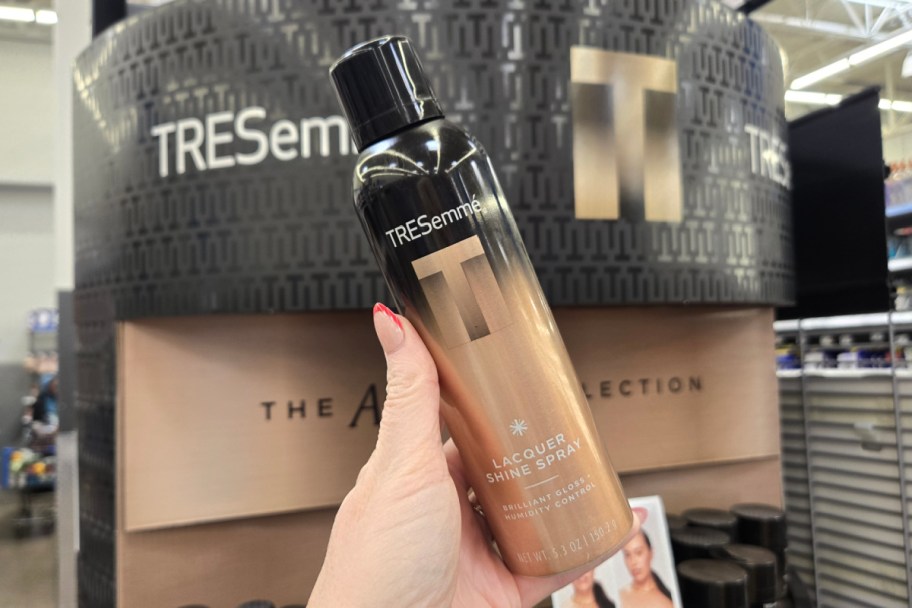 hand holding shine spray bottle in store