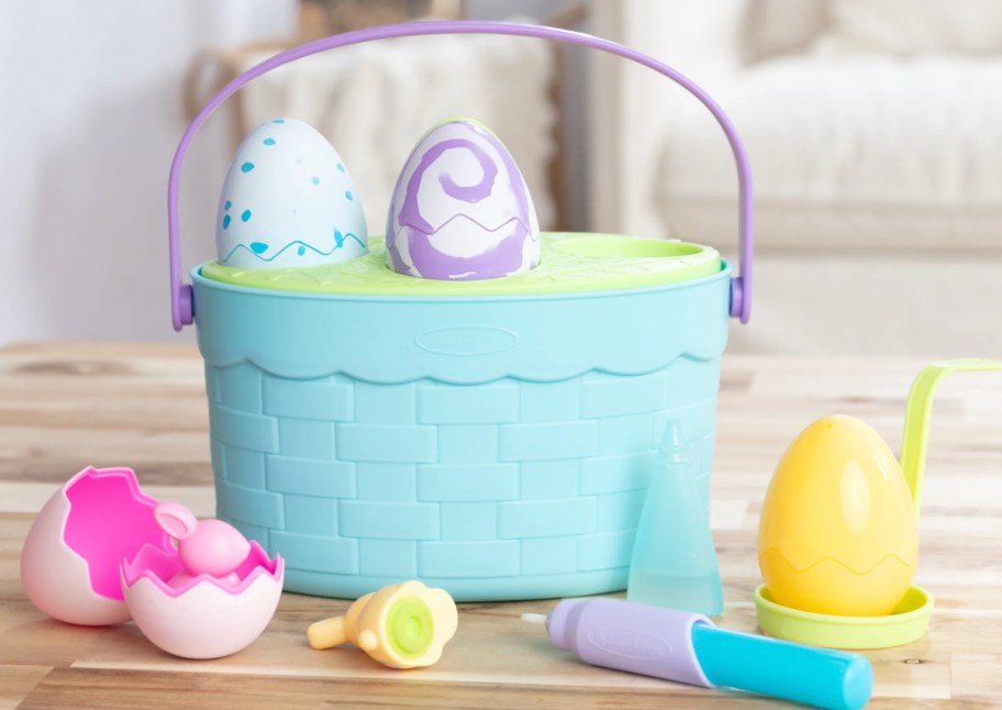 blue easter basket with fake colorful eggs
