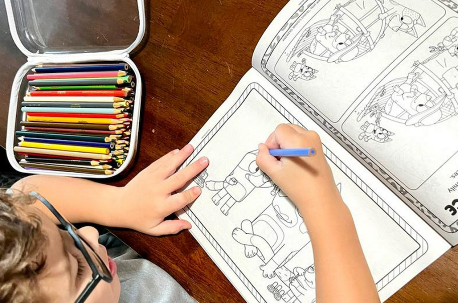 boy coloring in Bluey coloring book 