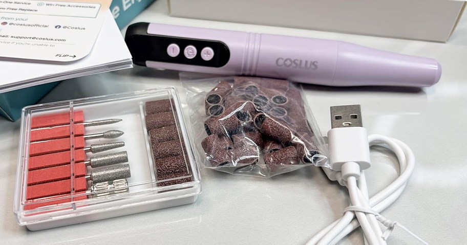 purple nail drill and accessories on counter 