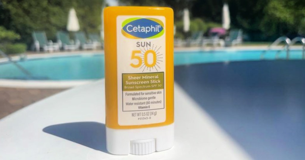 Cetaphil sunscreen stick on pavement next to pool