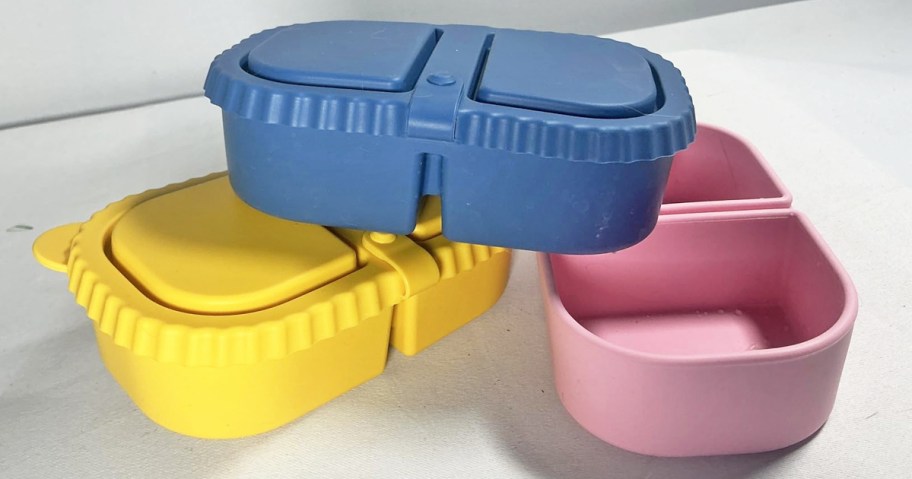blue, yellow, and pink silicone snack containers