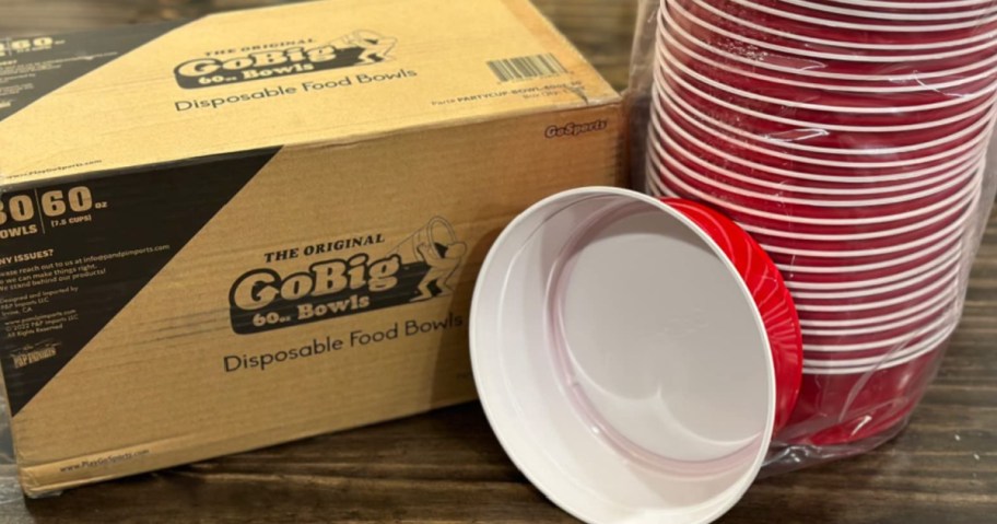Go big red bowls next to cardboard shipping box