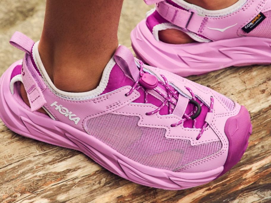 Childs Feet Wearing Pink HOKA Hopara 2 Kids Shoes