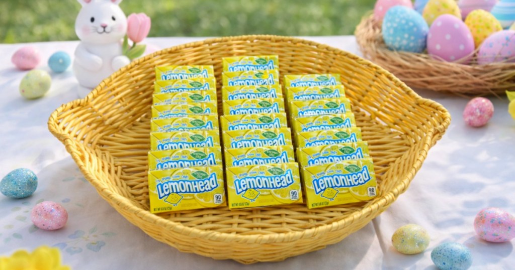 Lemonhead candy boxes in basket on top of spring themed table