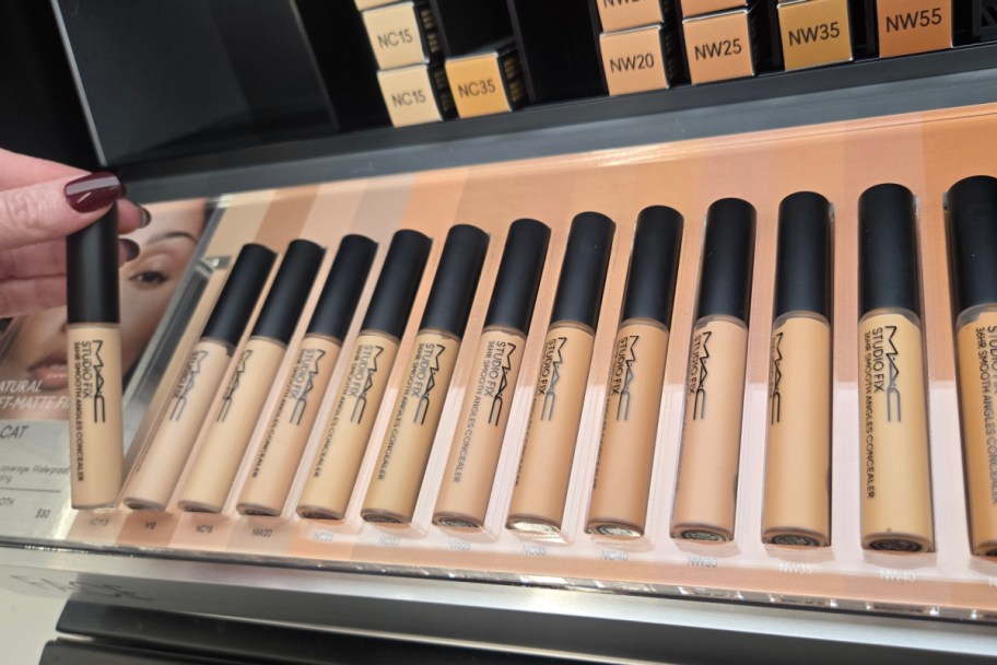 many concealer tubes in a row on store shelf