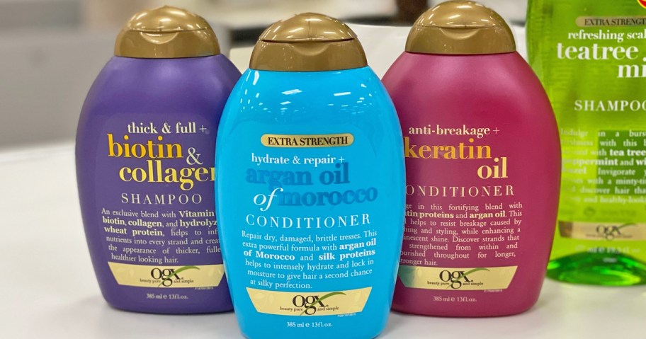 purple, blue, and pink bottles of OGX Shampoo & Conditioners