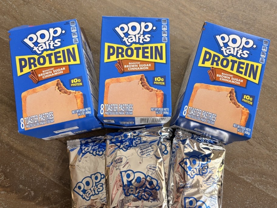 3 boxes of protein pop-tarts in brown cinnamon sugar flavor with packages out on table