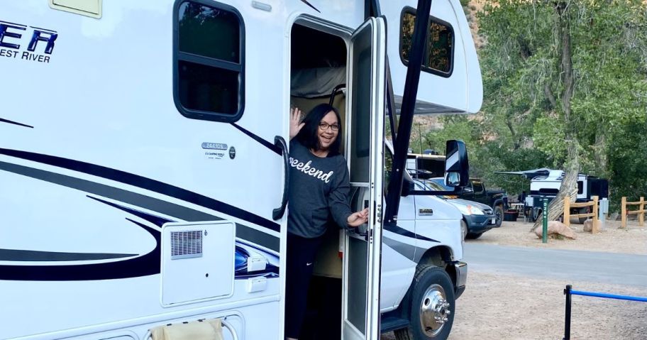 woman waving outside of rv 