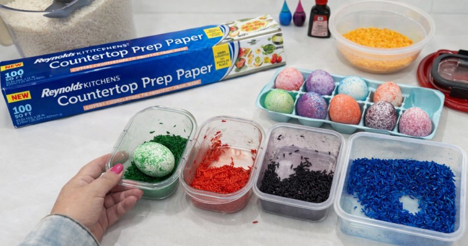 Woman dying Easter eggs on top of Reynolds countertop prep paper