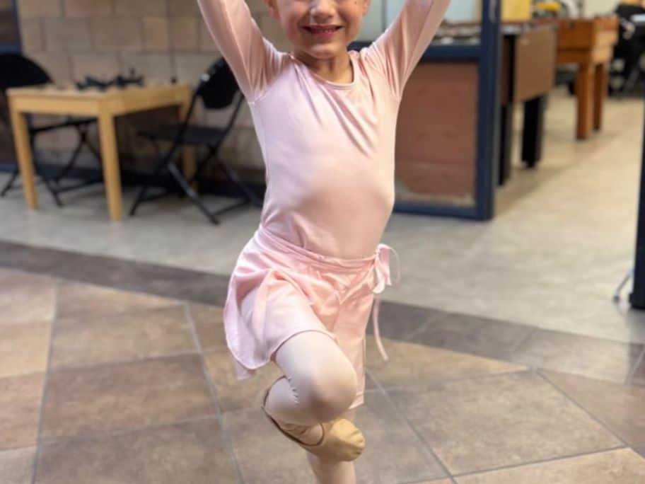 girl posing in a ballet leotard