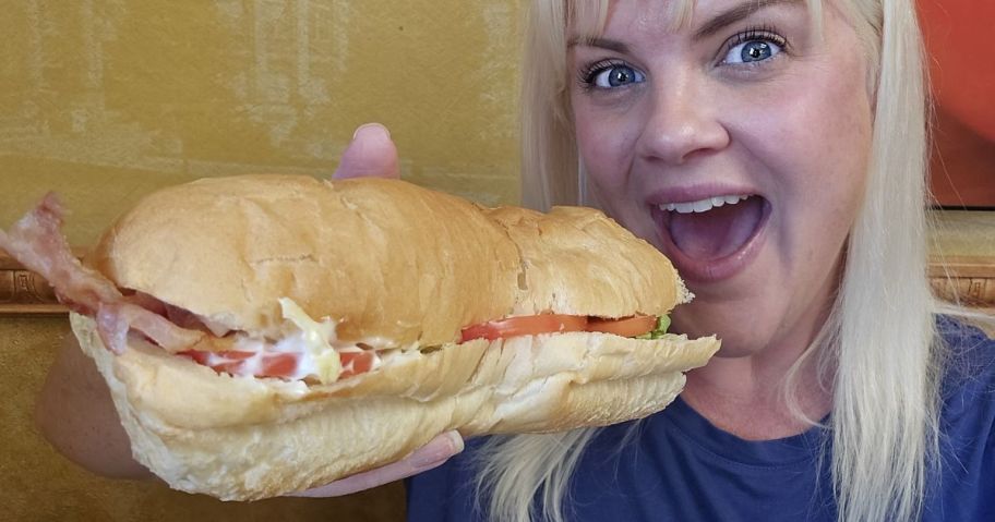 Woman eating a Subway Footlong