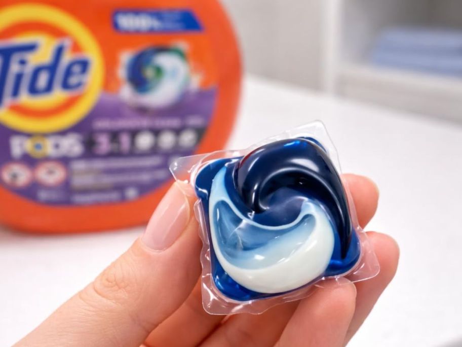 Hand holding a Tide Pod