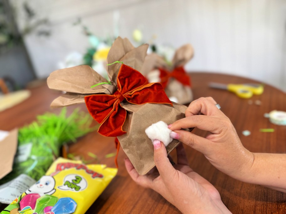 adding a cotton ball tail to bunny bag