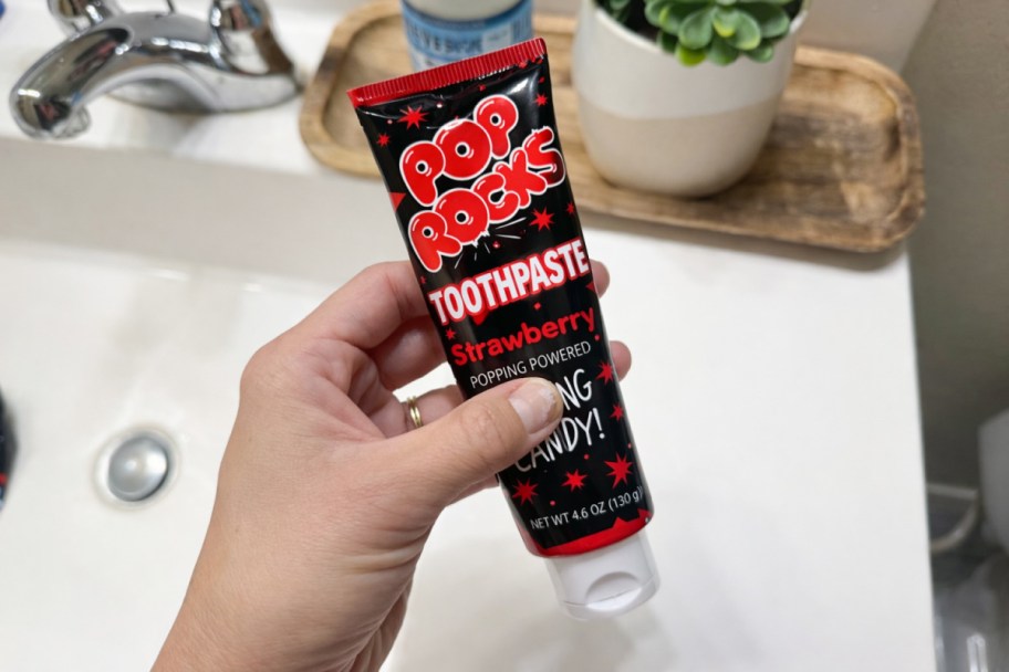 hand holding tube of pop rocks toothpaste