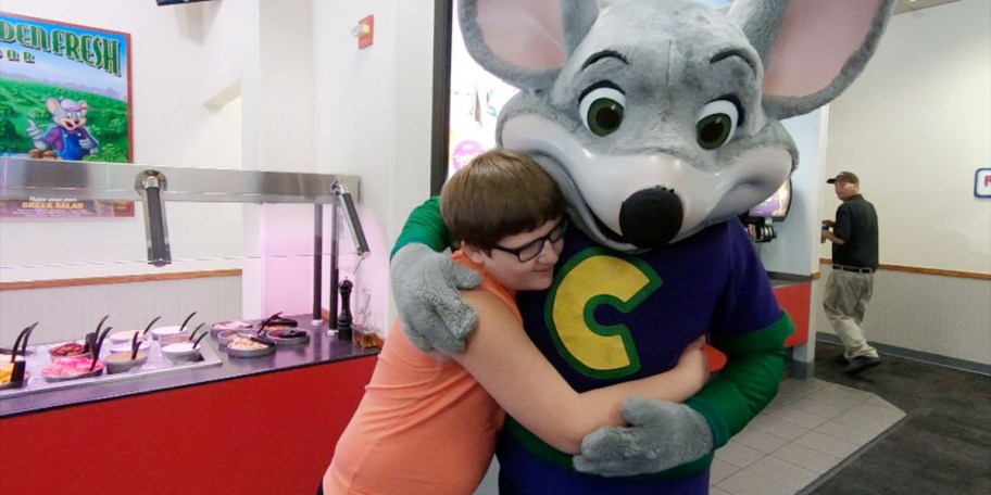 child hugging chuck e cheese