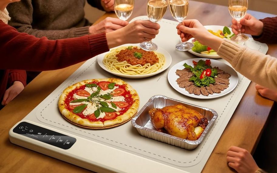 Multiple people sitting at a table with a warming mat infront of it 
