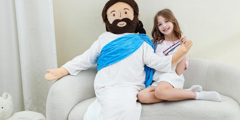 girl sitting on couch with jesus plush 