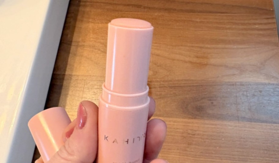 kahi balm stick in a woman's hand