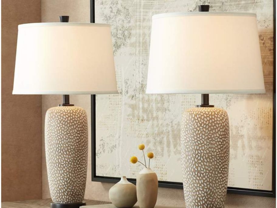 two lamp shades on top of the table