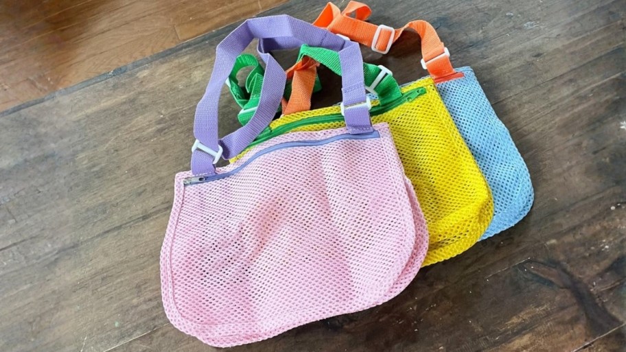 three colorful mesh seashell collecting bags