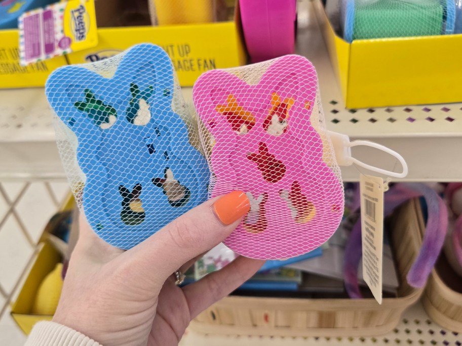 hand holding pink and blue slinky 