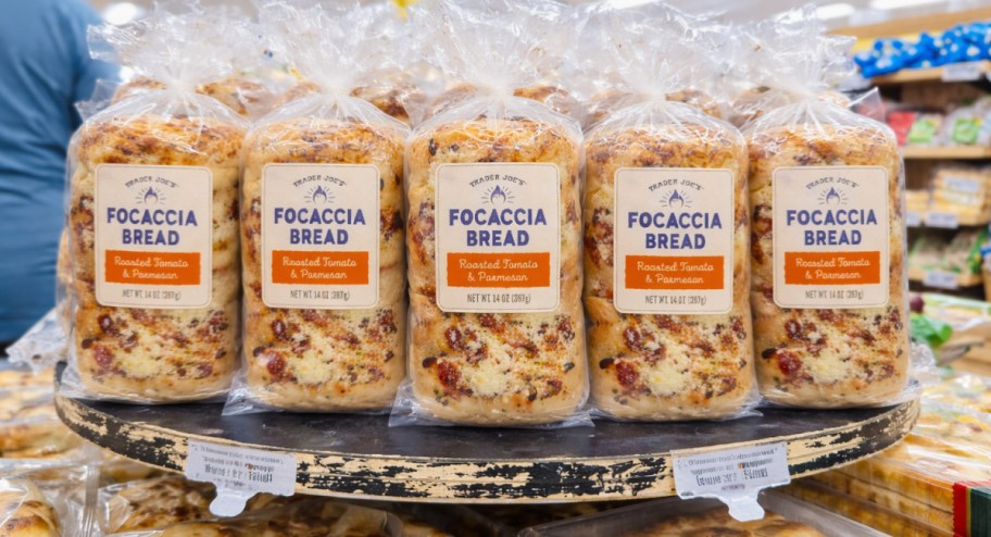 shelf of many focaccia breads in store