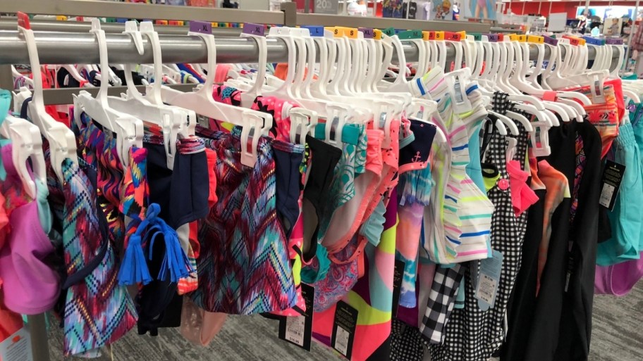 kids cat and jack swimsuits on a store rack