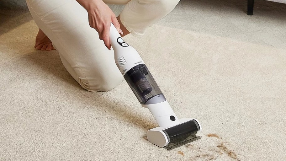 tineco mini hand vac vacuuming up pet hair from carpet