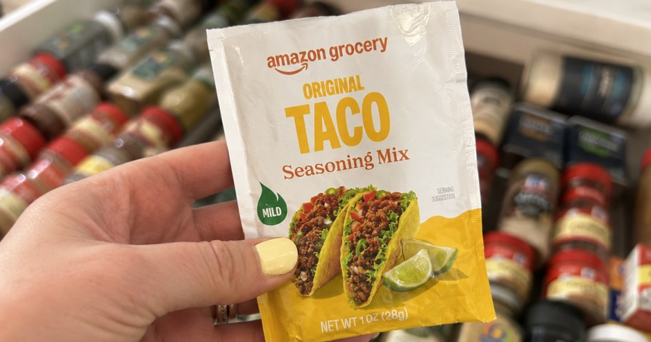 hand holding a packet of Amazon Grocery Taco Seasoning Mix