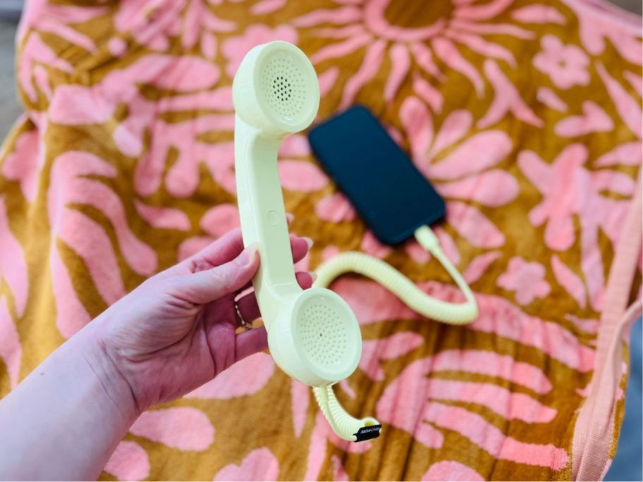hand holding Anthropologie Native Union Retro Pop Phone attached to cell phone